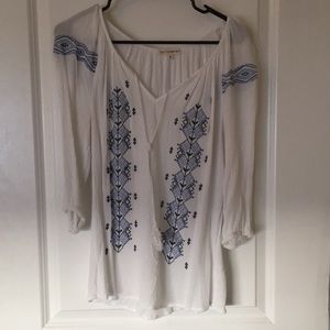 White 3/4 length sleeve shirt. Blue detail.